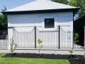 Wrought iron pool fence against the Georgian style poolhouse at Walkerville