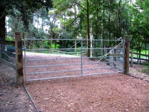 Estate gate with rabbit proof mesh overlay