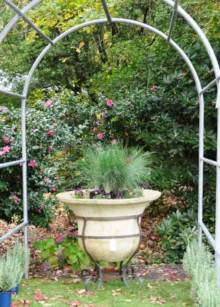 Large bell planter with wrought iron base