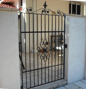 wrought iron courtyard gate with centre motif