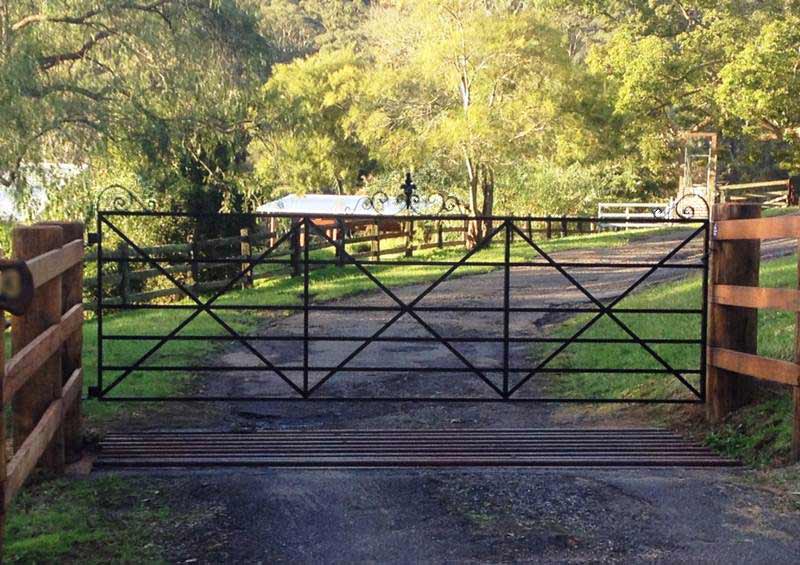 Eleanor steel driveway farm gate made by Farmweld is hinged to large heavy posts. Post and rail fences look great with Farmweld's heritage country style gates